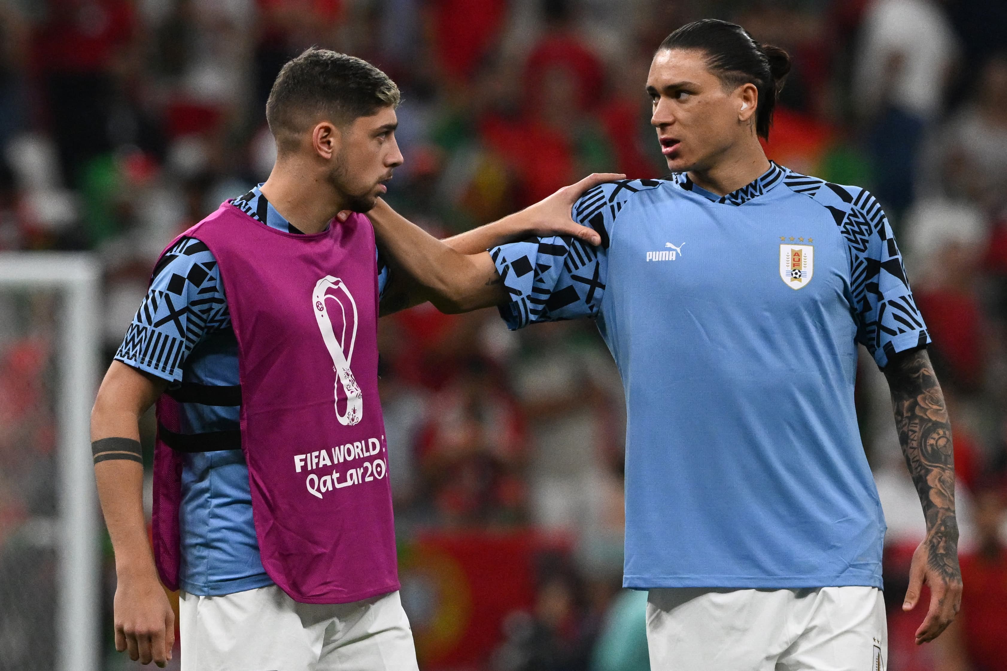 Uruguay's midfielder #15 Federico Valverde (L) and Uruguay's forward #11 Darwin Nunez warm up ahead of the start of the Qatar 2022 World Cup Group H football match between Portugal and Uruguay at the Lusail Stadium in Lusail, north of Doha on November 28, 2022. (Photo by Pablo PORCIUNCULA / AFP)