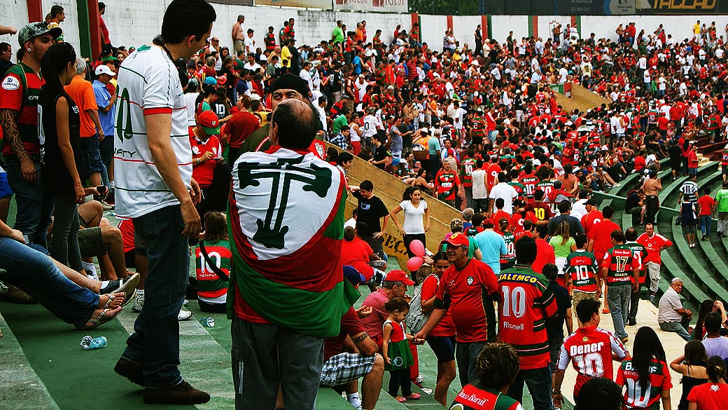 Torcedor se envolve em bandeira da Portuguesa em jogo no Canindé, no Pari