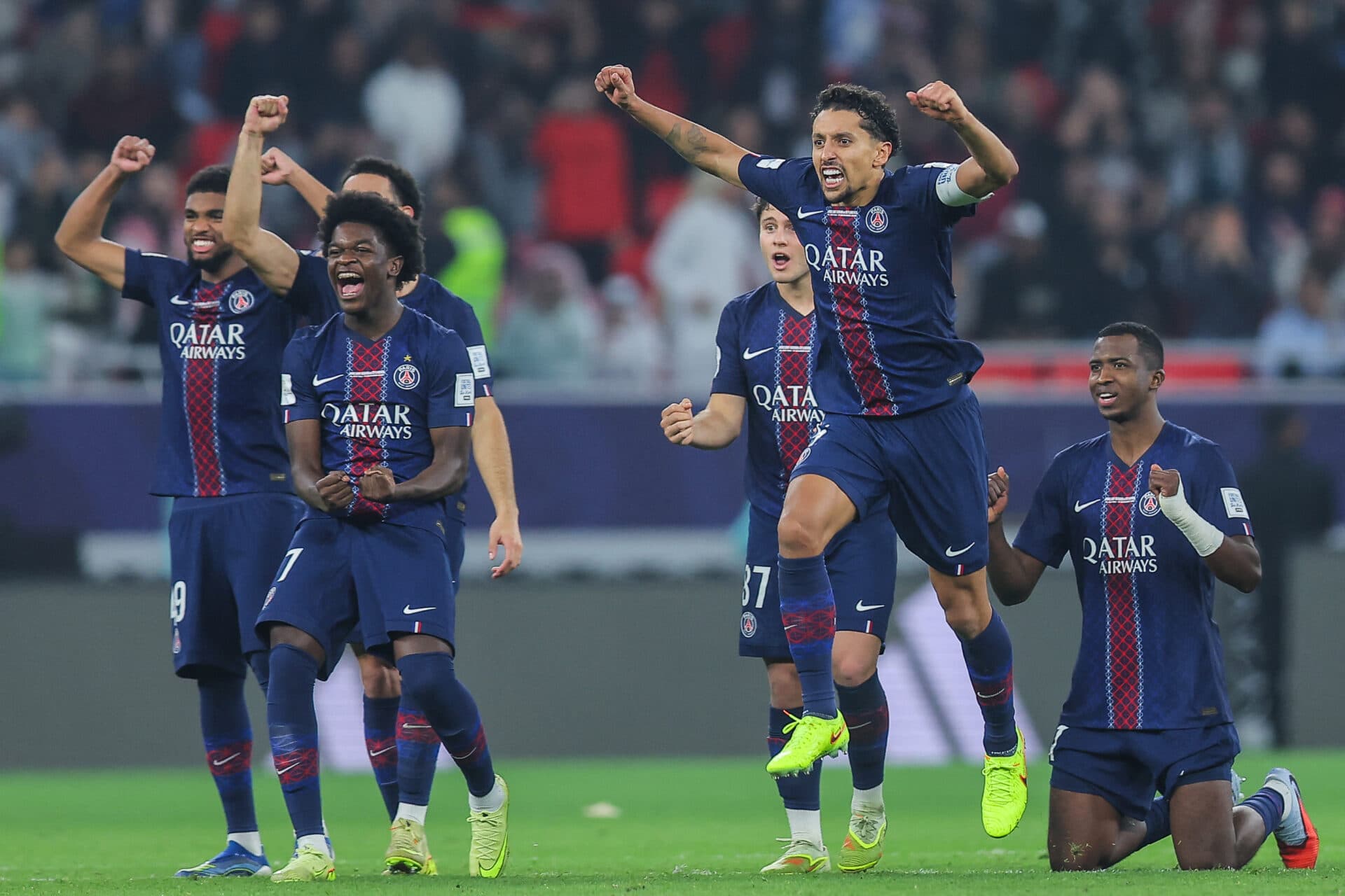 PSG's players celebrate during the penalty shootout at the end of the 2025 FIFA Intercontinental Cup final football match between Paris Saint-Germain (PSG) and CR Flamengo at the Ahmad bin Ali Stadium in Al-Rayyan on the outskirts of Doha on December 17, 2025. (Photo by Karim JAAFAR / AFP)