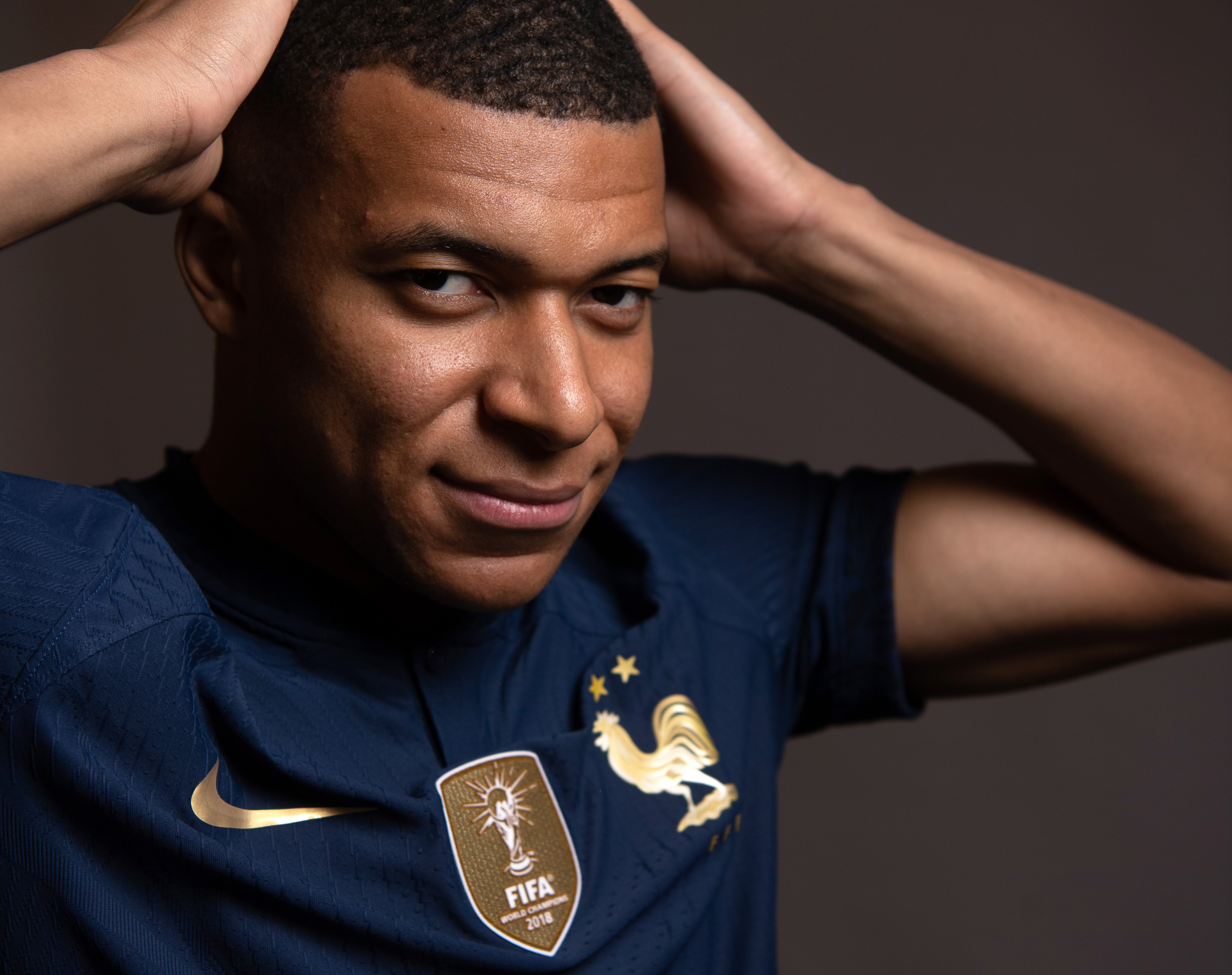 DOHA, QATAR - NOVEMBER 17: Kylian Mbappe of France poses for a photo during the official FIFA World Cup Qatar 2022 portrait session at the Al-Messila hotel on November 17, 2022 in Doha, Qatar. (Photo by Mike Hewitt - FIFA/FIFA via Getty Images)